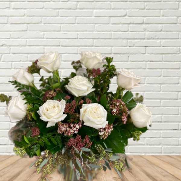 White rose bouquet with pink filler flowers and greenery