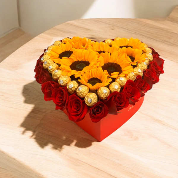 Heart-shaped box with sunflowers, red roses, and gold-wrapped chocolates