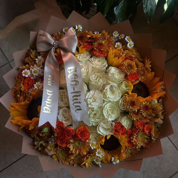 Bouquet of white and orange roses with sunflowers and daisies