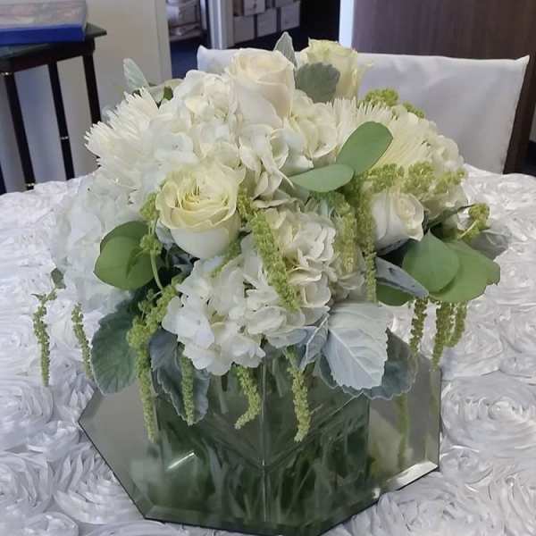 White floral bouquet in a mirrored hexagonal vase