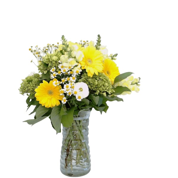 Yellow and white flower bouquet in a clear glass vase