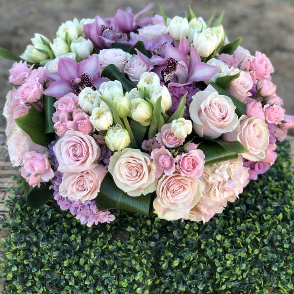 Pink and white bouquet with roses, tulips, and orchids