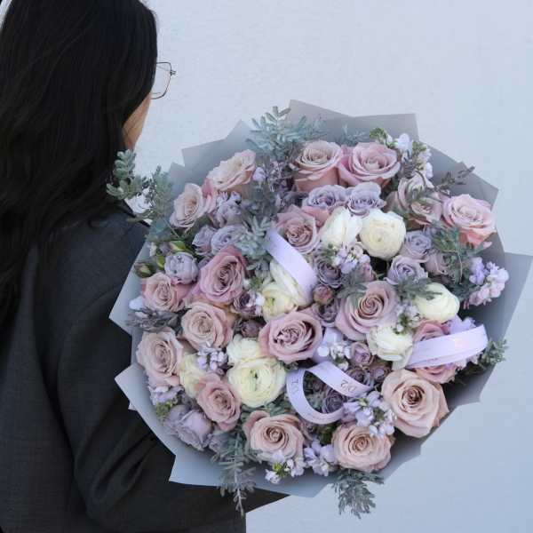 Large bouquet of blush and lavender roses with pale filler flowers