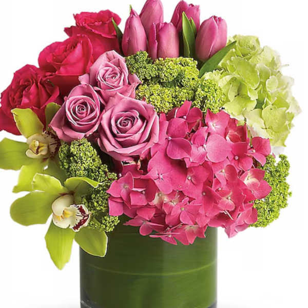 Pink roses and tulips with hydrangea in a green glass vase