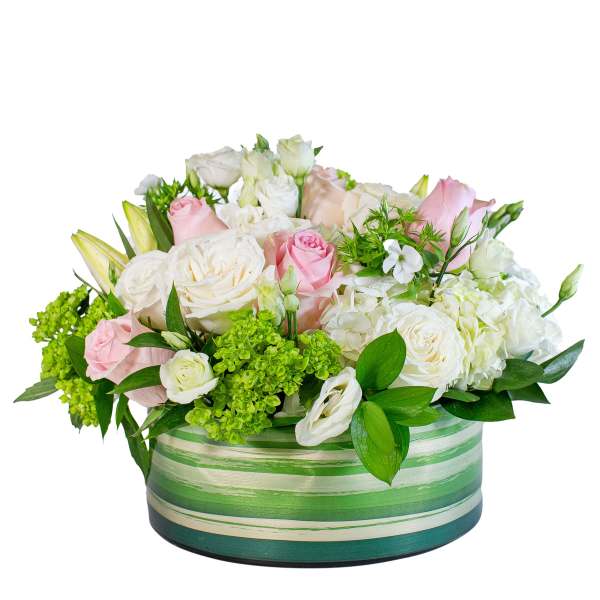 Pink and white roses arranged in a striped green container