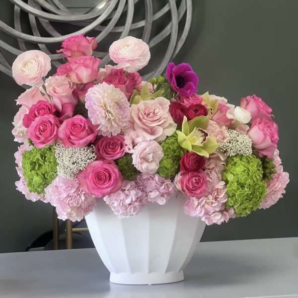 Pink and white floral arrangement in a white vase
