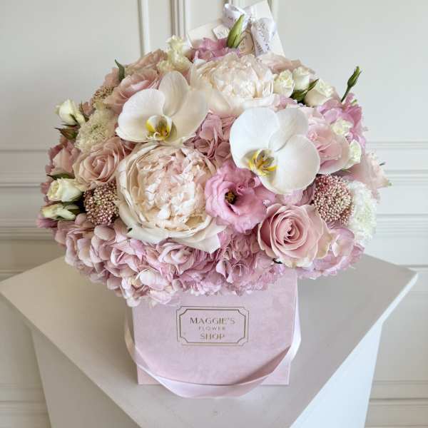 Pink and white bouquet in a pastel box with orchids and roses