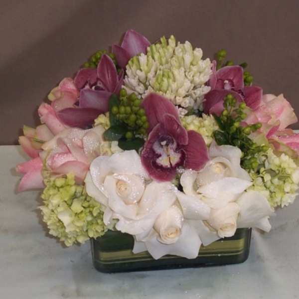 Pink and white floral arrangement in a rectangular vase