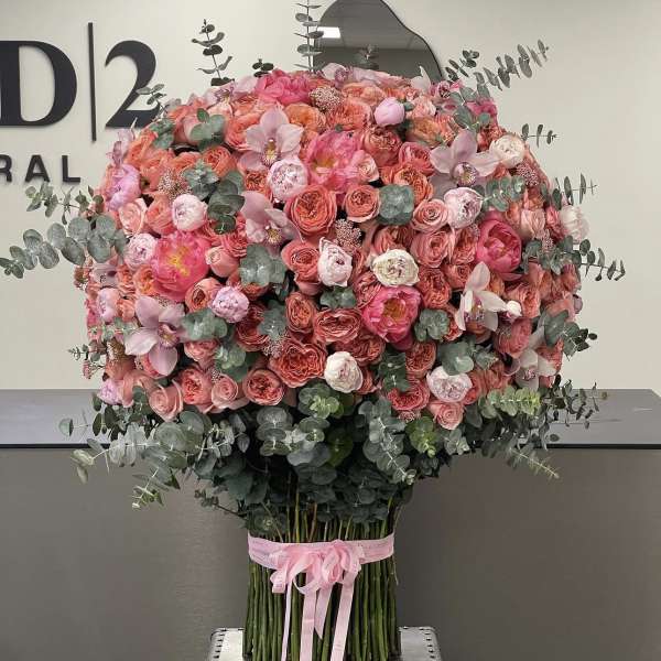 Large pink and coral rose bouquet with eucalyptus and a pink ribbon