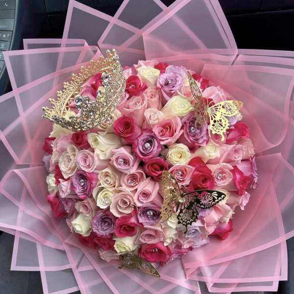 Pink rose bouquet with butterfly decorations and sheer wrapping