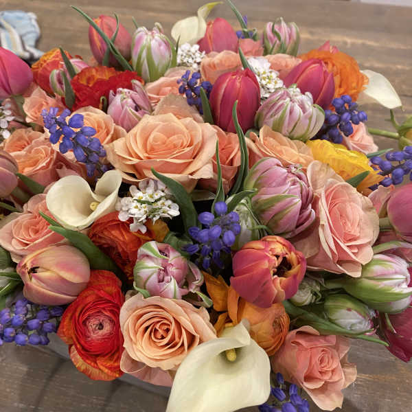 Mixed bouquet of pink roses, tulips, calla lilies, and purple accents