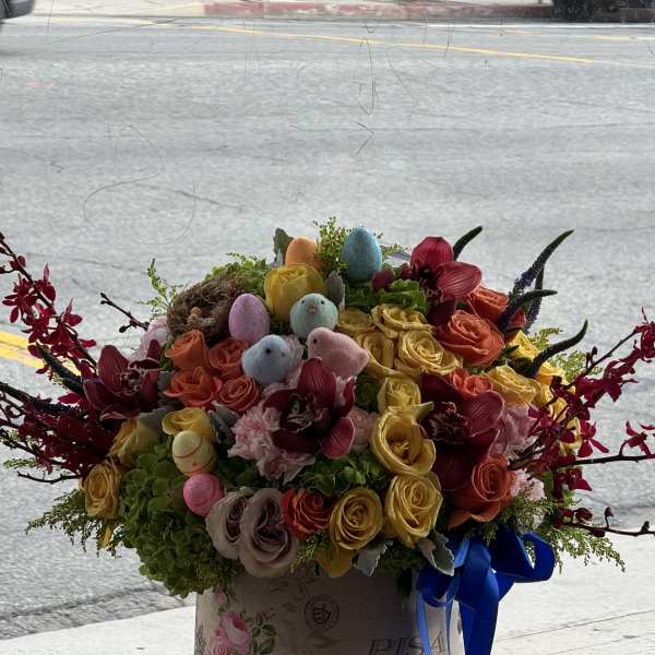 Colorful bouquet of roses with pastel Easter eggs in a box