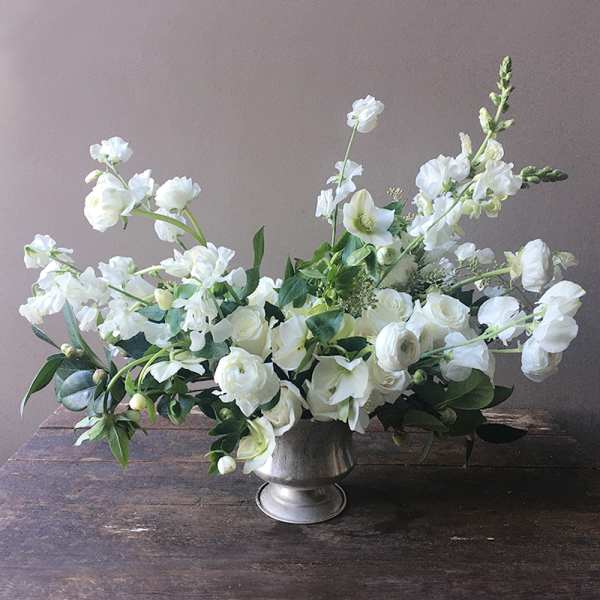 White floral arrangement in a silver vase