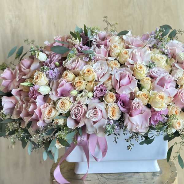Large pastel bouquet of pink and cream roses in a white box
