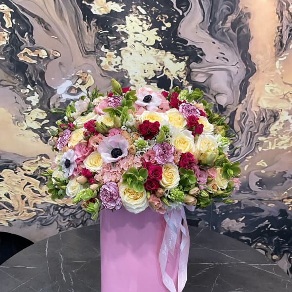 Large mixed bouquet in a pink cylindrical box with ribbon