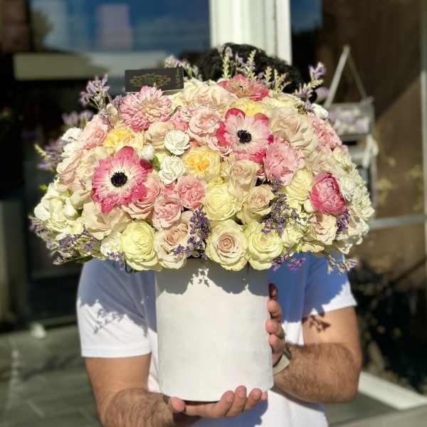 Large pastel bouquet of roses and pink anemones in a white hat box