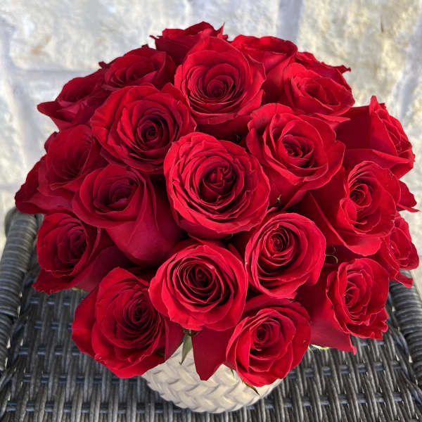 Bouquet of red roses in a white textured vase