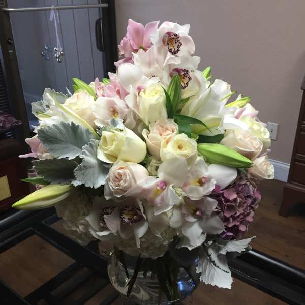Bouquet of white and blush flowers in a glass vase