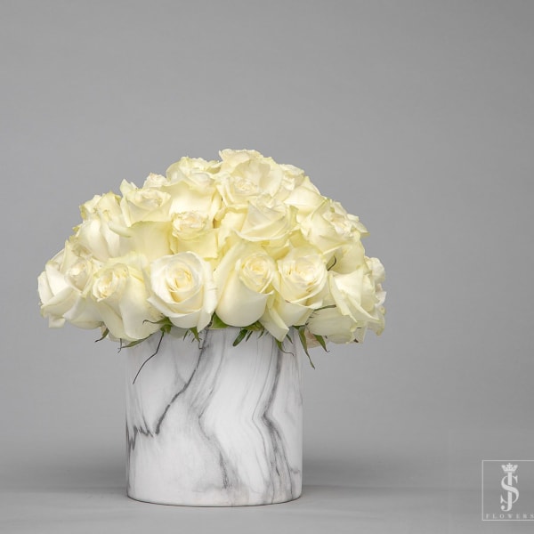 White rose bouquet in a marble-patterned vase