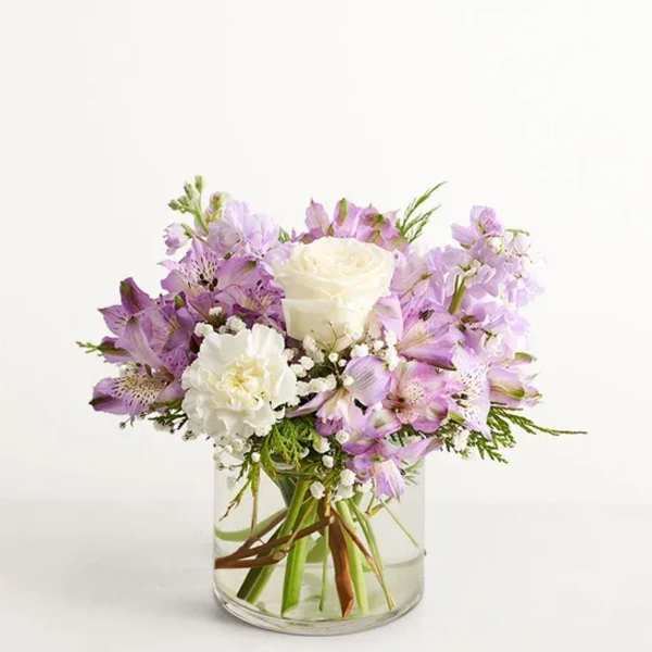 Lavender and white bouquet in a clear glass vase