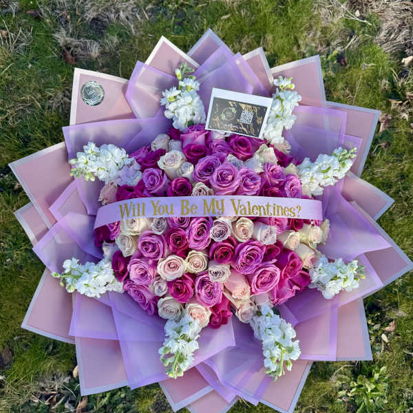 Large bouquet of pink and lavender roses with a Valentine ribbon