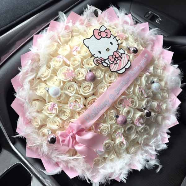 Large bouquet of cream roses with pink wrapping and a Hello Kitty topper
