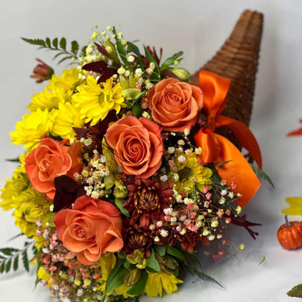 Orange roses and yellow daisies in a wicker cone with ribbon