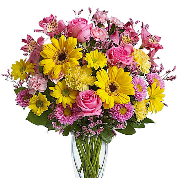 Bouquet of pink and yellow flowers in a clear glass vase