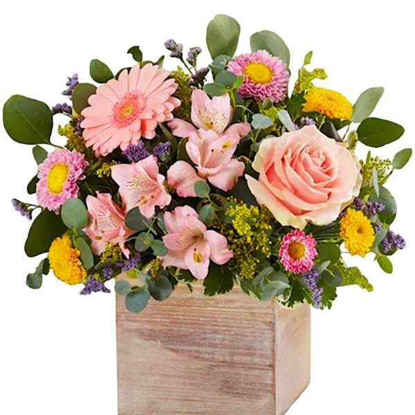 Mixed pink and yellow flowers in a wooden box