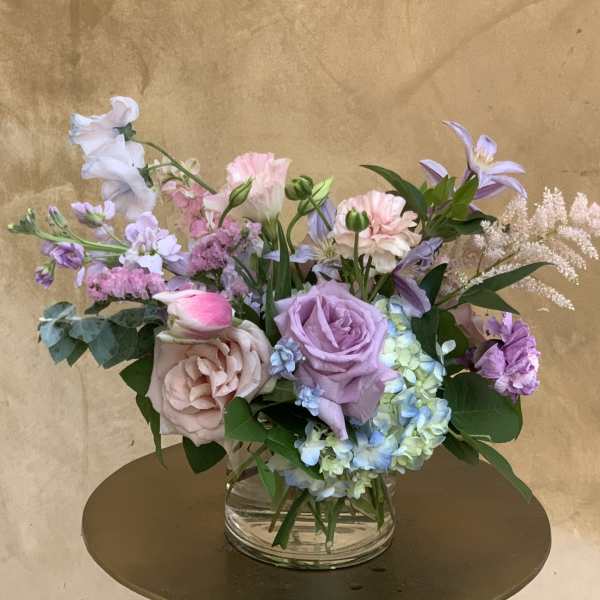 Pastel mixed flower arrangement in a clear glass vase