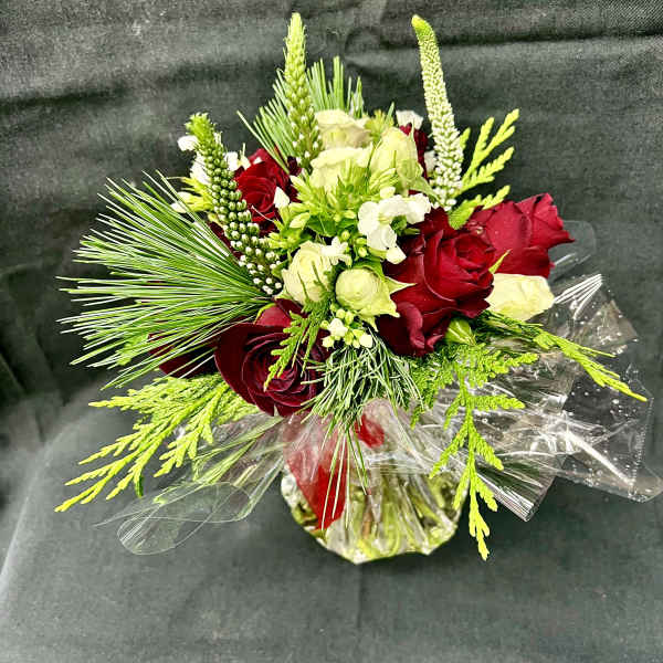 Bouquet of red and white roses with green accents in clear wrap