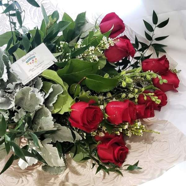 Bouquet of red roses with silver foliage and pink ribbon