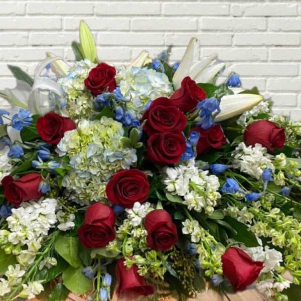 Large bouquet of red roses, white lilies, and blue flowers
