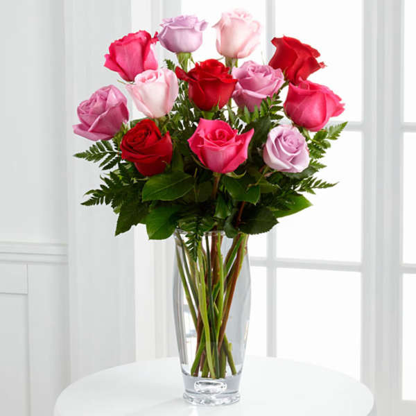 Bouquet of pink and red roses in a clear glass vase