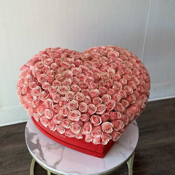 Heart-shaped box filled with pink roses