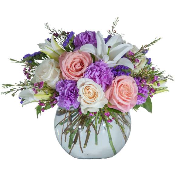 Bouquet of pink and white roses with purple flowers in a glass vase