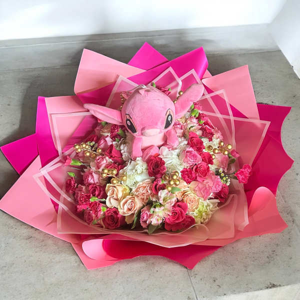 Pink bouquet with a plush character in the center
