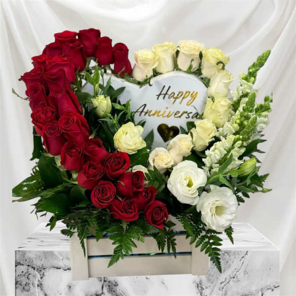 Heart-shaped rose arrangement with a Happy Anniversary sign