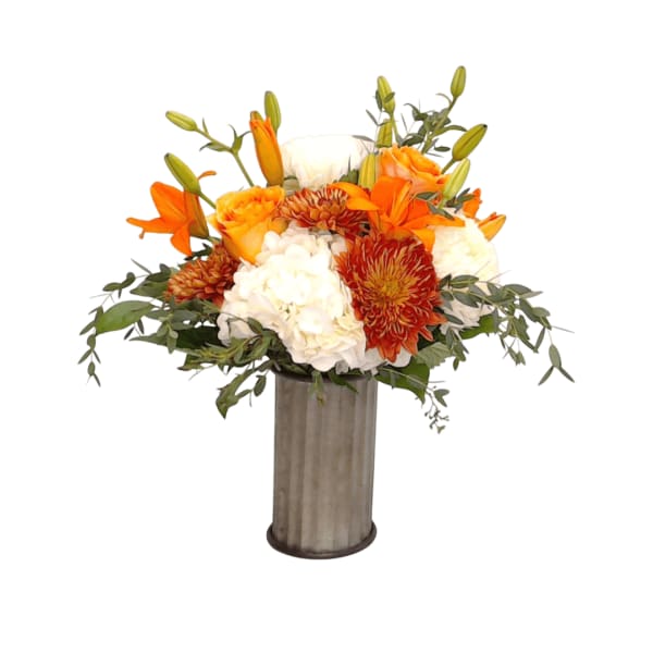 Orange and white floral arrangement in a tall metal vase