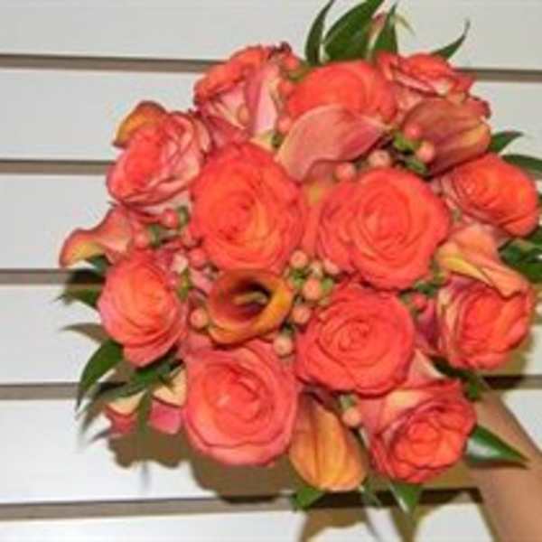 Coral rose bouquet with calla lilies and greenery