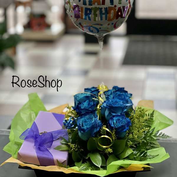 Blue roses with a happy birthday balloon and gift box