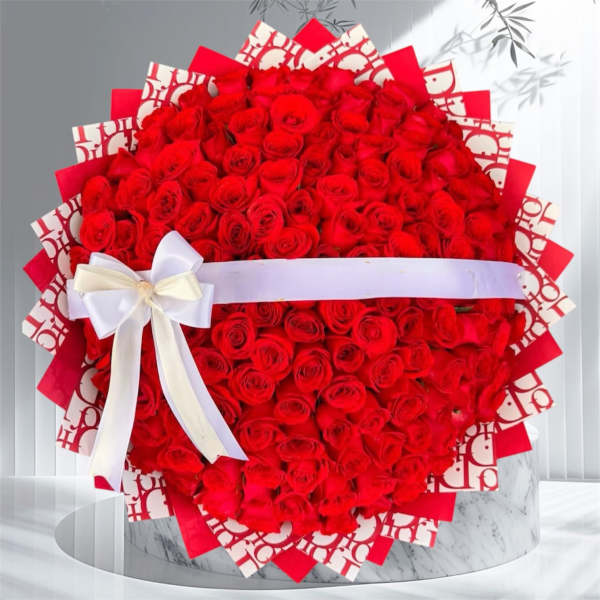 Large bouquet of red roses wrapped with a white ribbon