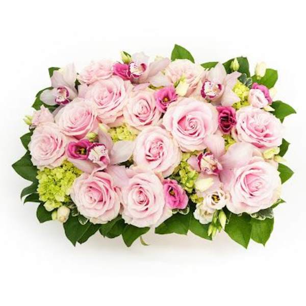 Low rectangular arrangement of pale pink roses, green hydrangeas, and pink blooms in a compact design