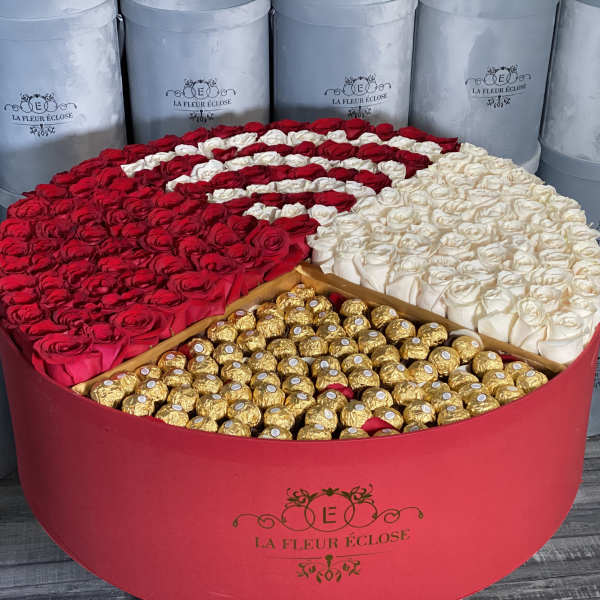 Heart-shaped box of red and white roses with gold-wrapped chocolates