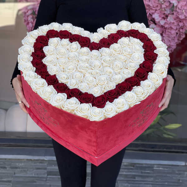 Heart-shaped box filled with red and white roses