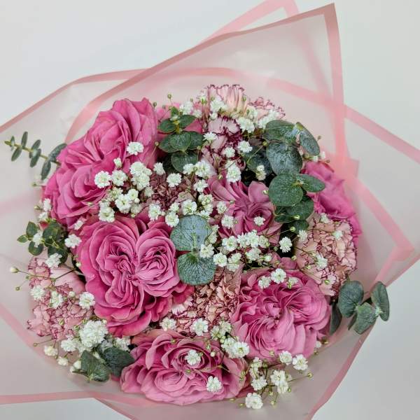 Pink rose bouquet with white baby's breath and eucalyptus in pink wrap
