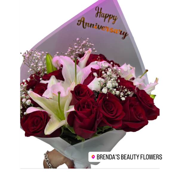 Bouquet of red roses and white lilies with an anniversary card