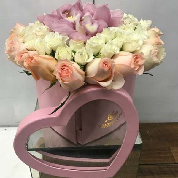 Pink and white rose bouquet in a pink heart-shaped box