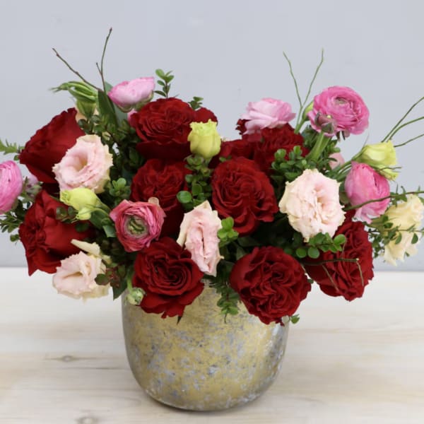 Red and pink rose bouquet in a gold vase