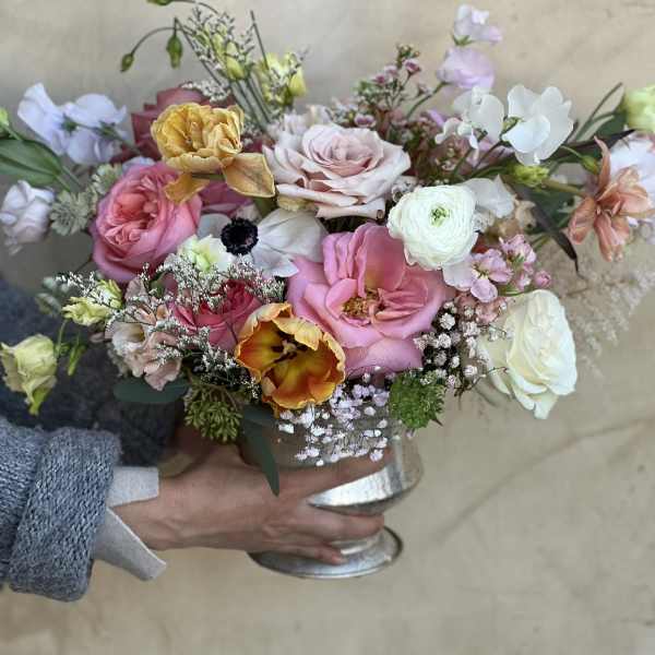 Mixed pastel bouquet in a silver vase with roses and tulips